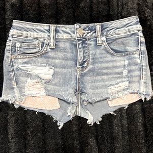 Denim distressed shorts with lace accent low rise
